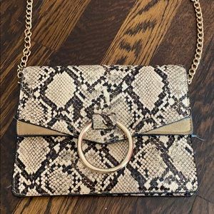 Snakeskin crossbody that doubles as clutch.